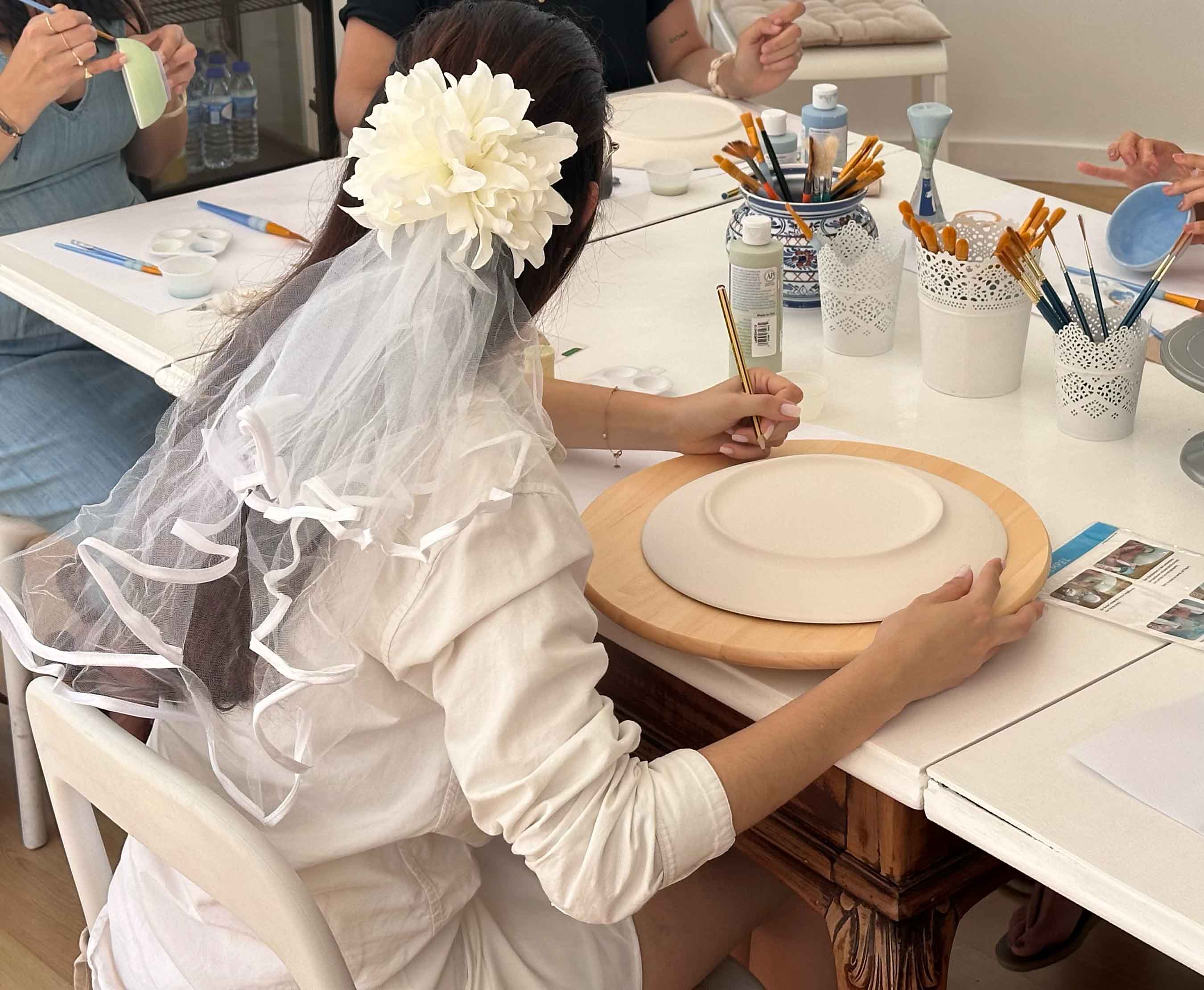 Adults celebrating with ceramic painting